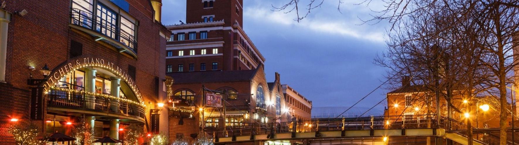 A shot of Brindleyplace and a selection of its restaurants by the canal, lit up at night