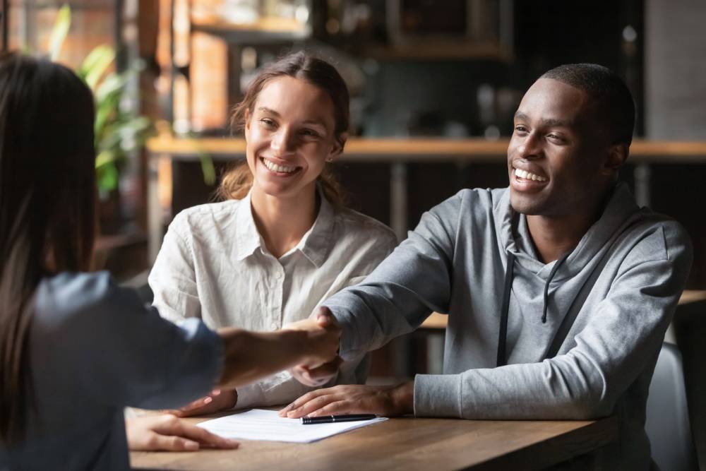 An image depicting two renters shaking hands with a letting agent, following the renters' rights bill.