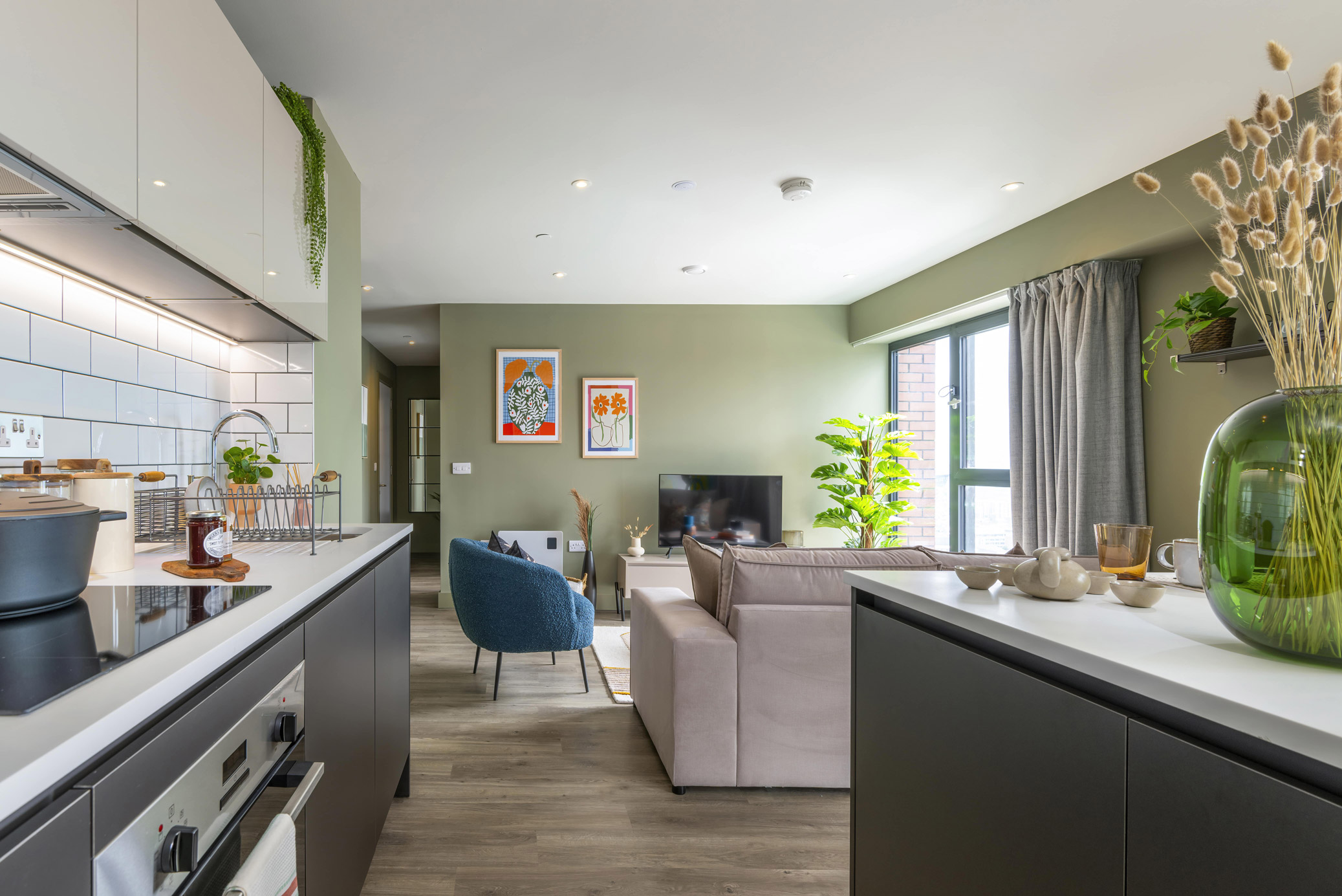 Modern apartment interior at Cortland Birmingham showing open-plan kitchen, lounge and dining space with natural light.