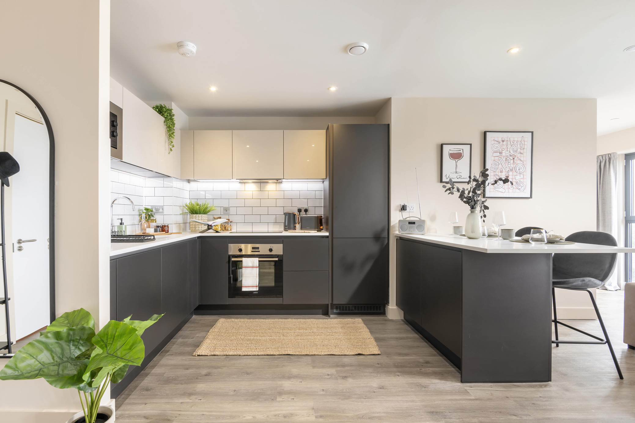 Open-plan apartment at Cortland Birmingham featuring modern kitchen, dining area and bright living space.
