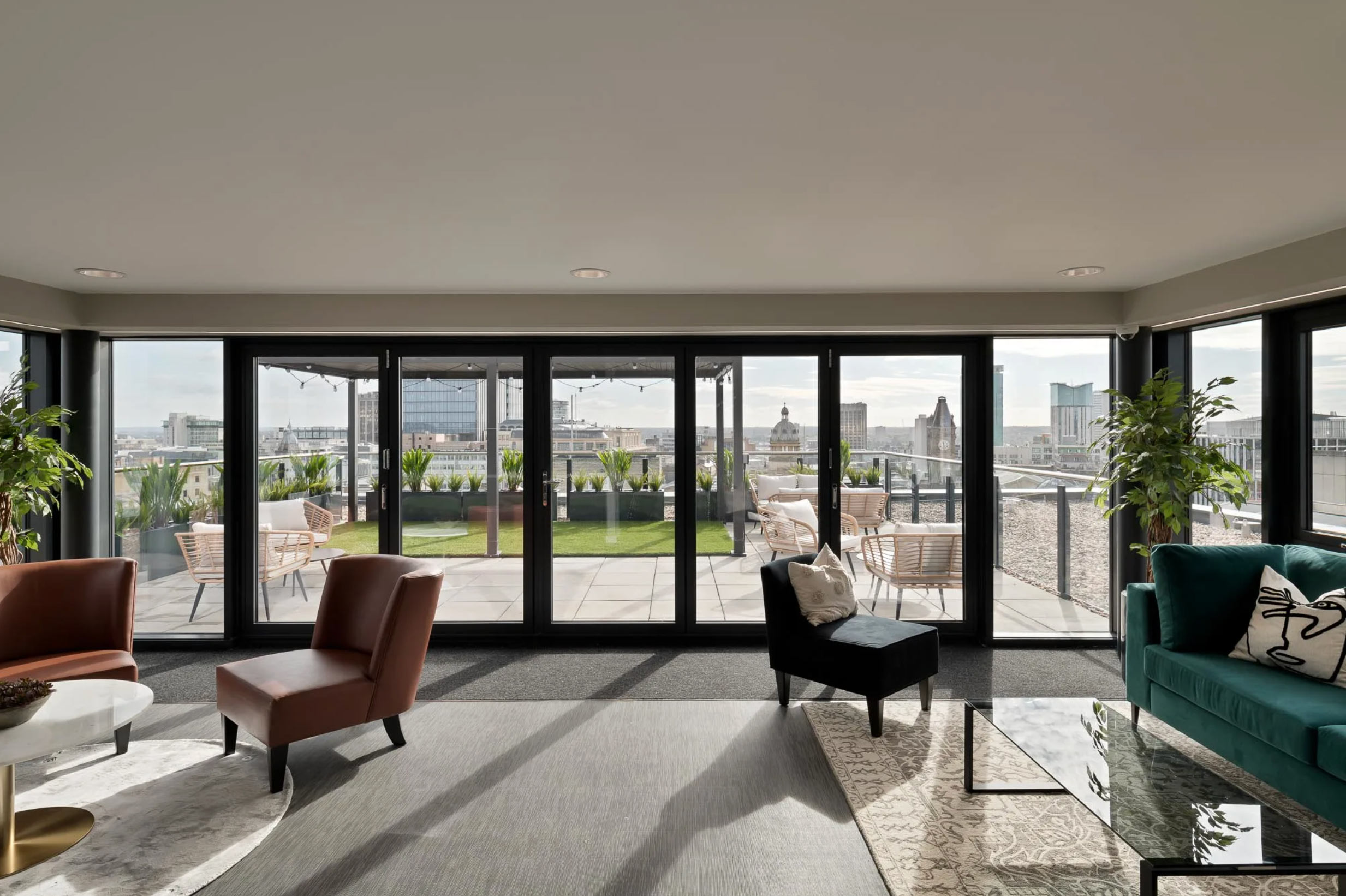 Rooftop lounge and terrace at Landrow Place Birmingham with skyline views and outdoor seating.