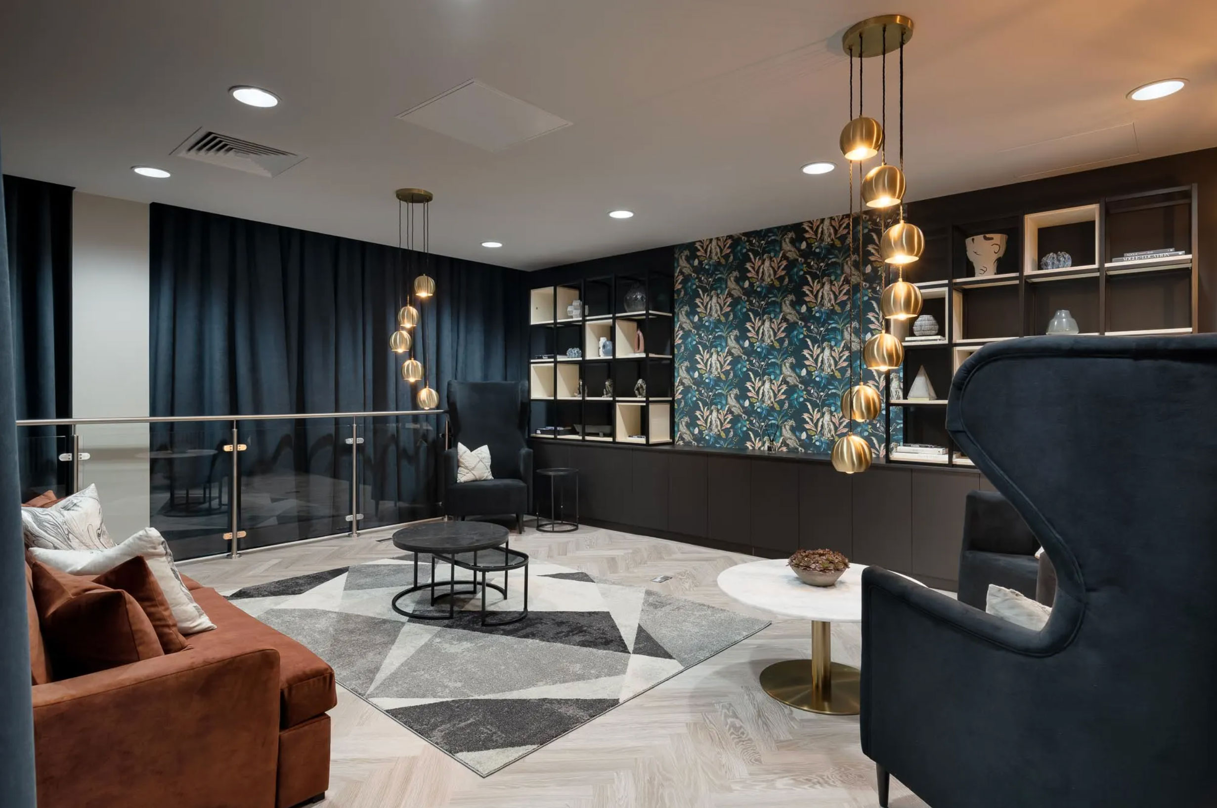 Elegant resident lounge at Landrow Place Birmingham with modern décor, velvet seating and feature lighting.